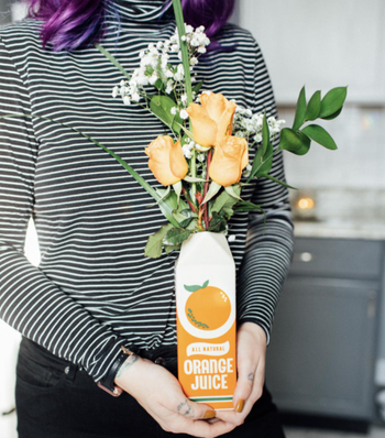 Reviewer holding the orange juice vase