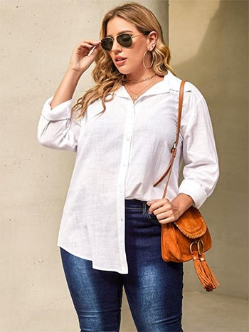 plus-size model wearing the white shirt half tucked into a pair of jeans