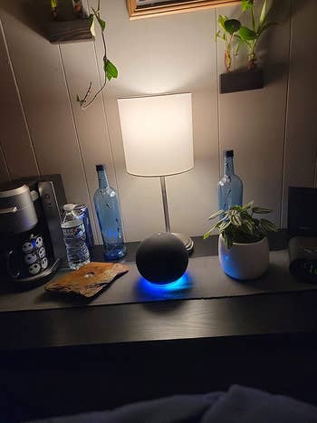 a reviewer photo of the echo in black with the glowing blue light underneath