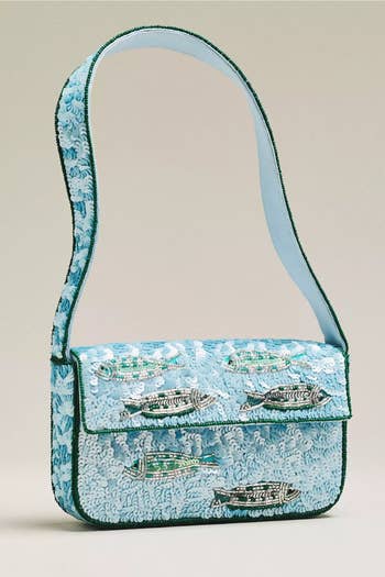 Embroidered handbag with intricate fish patterns and a shoulder strap, featured in a shopping article