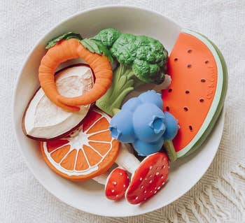 bowl of teething fruit and vegetable toys