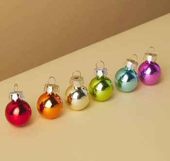 a red ornament, and orange ornament, a yellow ornament, a green ornament, a blue ornament, and a purple ornament