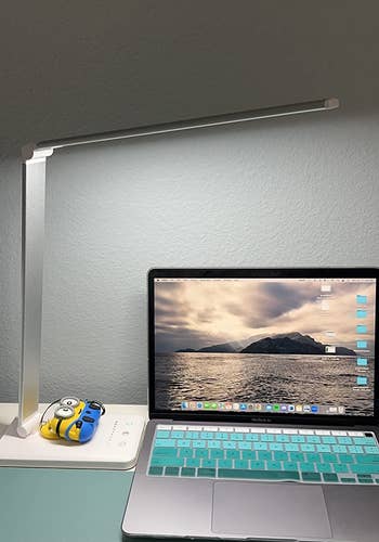 side view of another reviewer's white lamp over a laptop on a desk