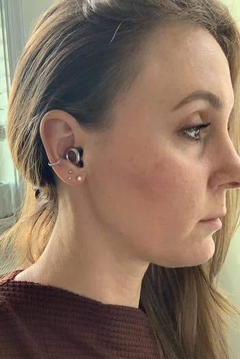 a reviewer wearing the silver plugs