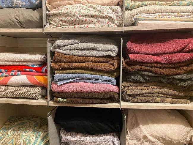 reviewer photograph of the support dividers dividing stacks of folded towels