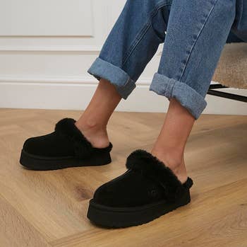 a model wearing the platform slippers