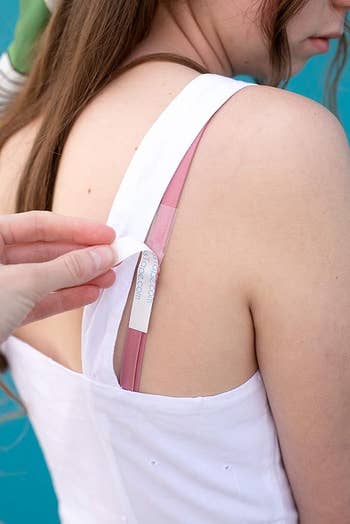 A manus  applies a portion    connected  bra strap