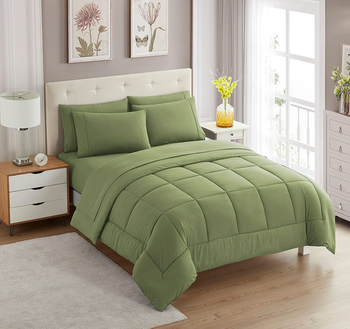 Green square stitched comforter with matching pillowcases on a white tufted bed frame