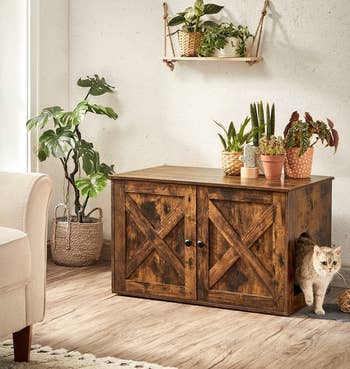 rustic brown litter box enclosure with cat peeking out one side of it