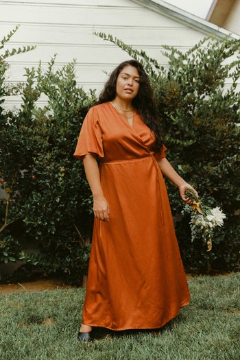a model posing in the rust orange color