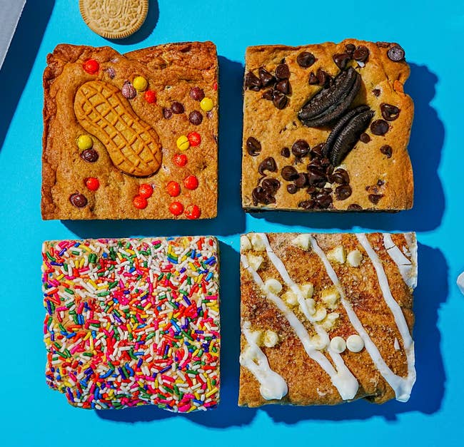1 with candy and a peanut food cookie, 1 with cocoa chips and sandwich cookies, 1 with sprinkles, and 1 with icing and achromatic cocoa chips