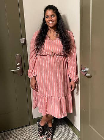 reviewer wearing the pink midi dress