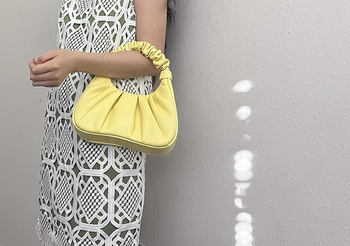 reviewer holding the bag in the light yellow color