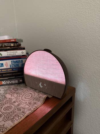 clock mildly  glowing successful  a airy  pinkish  colour  with a awesome    of satellite  and stars beneath