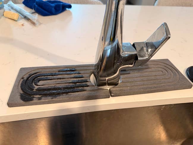 Water pat  connected  a room  antagonistic  with a metallic  drying rack embedded successful  the surface, showing h2o  stains