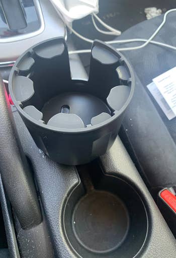 The car cup holder empty, showing the device adapter insert