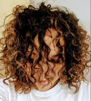 Reviewer with curls showing effect of the cream 