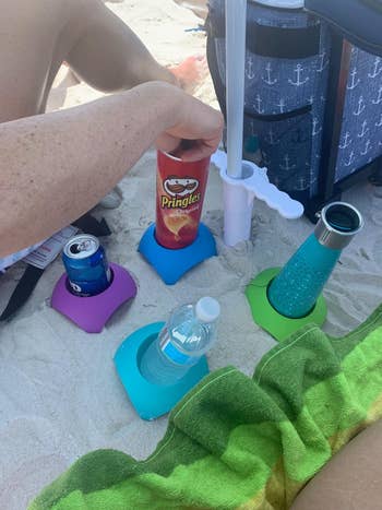 reviewer's set of four cup holders int he sand