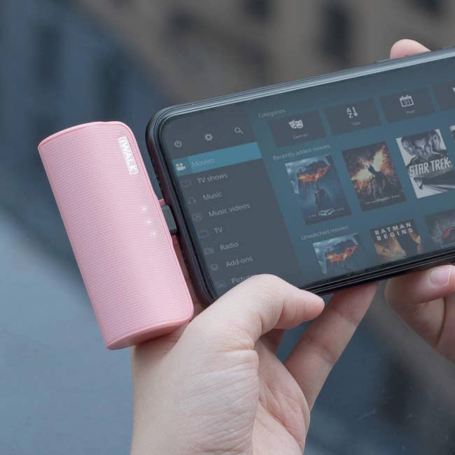 the pink iWalk portable charger inserted into an iPhone