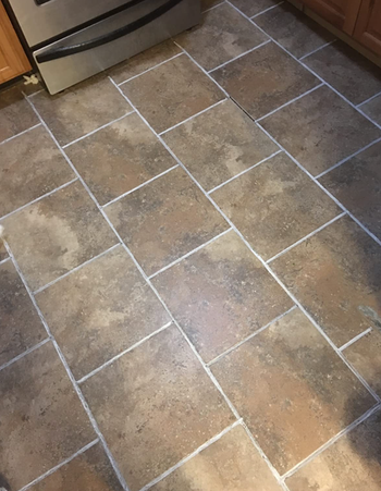 the same tile floor now looking clean after using the grout pen