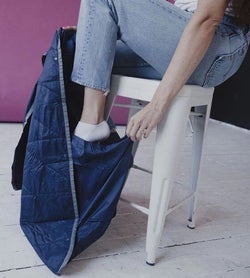 model putting their foot into the blanket's foot pocket