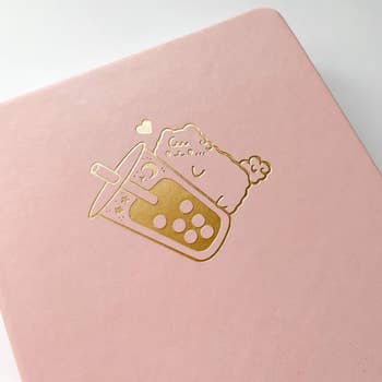 close-up of the gold embossing on the pink bullet journal