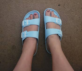 reviewer wearing the airy bluish sandals