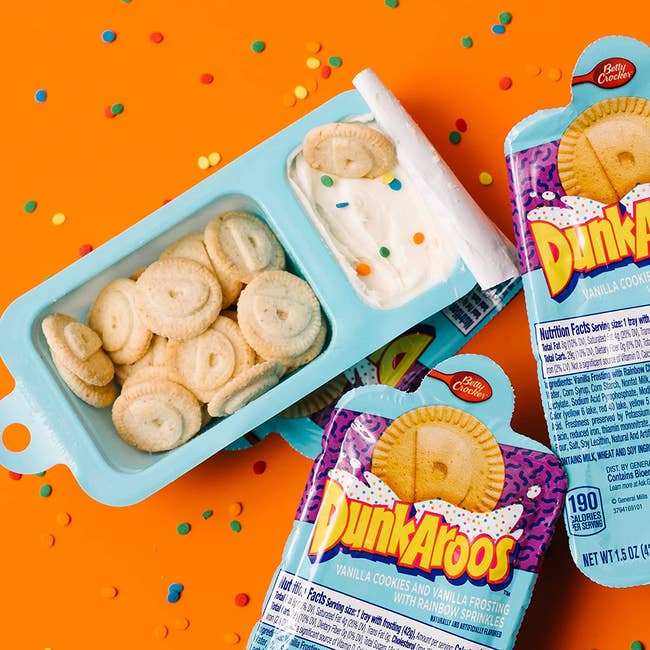 A snack pack with one section for small round cookies and another for frosting
