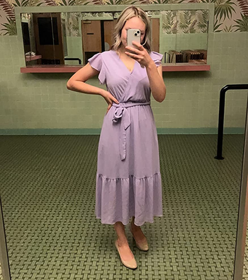 reviewer wearing a light purple dress with cream-colored flats