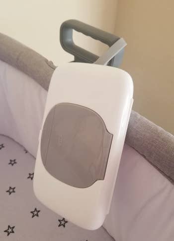 bag of travel wipes on side of baby crib