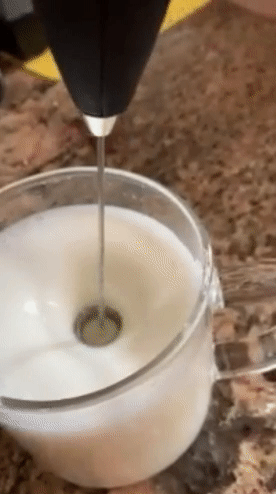gif of reviewer using the frother to make their milk foamy