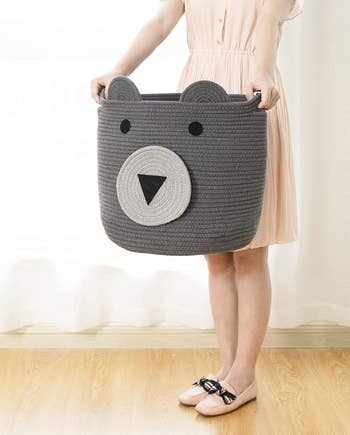 model carrying gray bear face basket