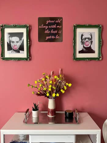 a reviewer's pink wall art showing the brides of frankenstein and frankenstein