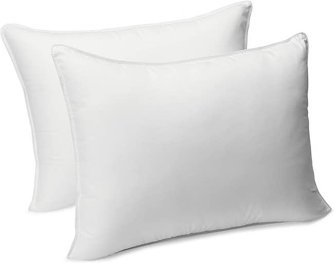Two standard white pillows without any persons in the image, relevant for bedding shopping content