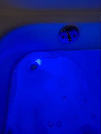 The blue light in the bathtub making it glow once the bath fizz is dissolved 
