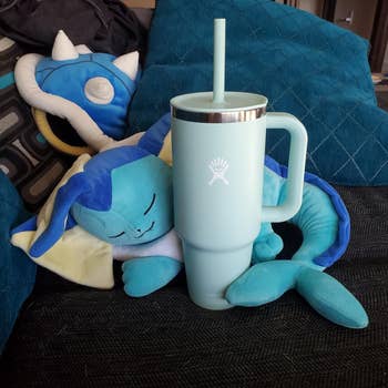 blue hydroflask with stuffed animal next to it