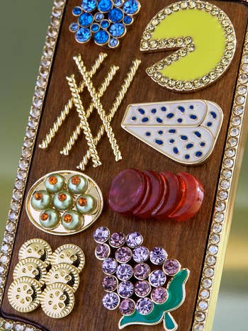 close up on metal and rhinestone crackers, cheese, olives, and fruit details