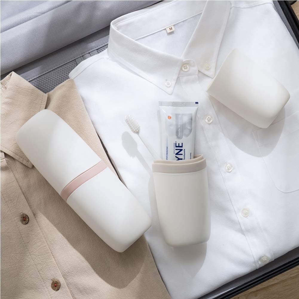 the white container on a pile of shirts, open to show how it fits a toothbrush and toothpaste in it