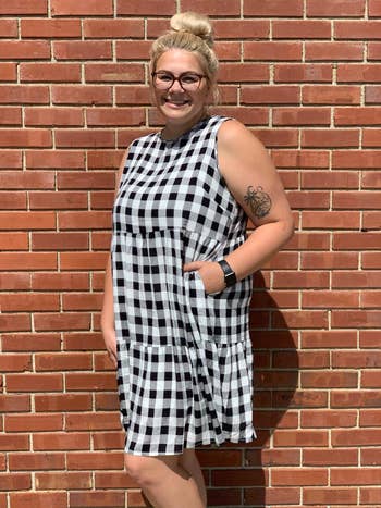 reviewer wearing the black and white gingham dress