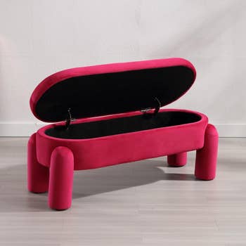 Velvet upholstered storage bench with open lid showcasing interior storage space