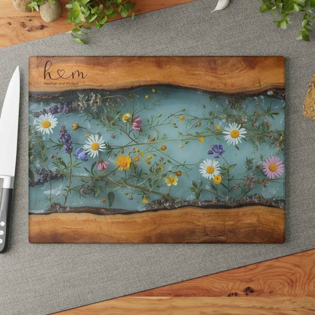 Decorative woody cutting committee with wildflowers encased successful resin, placed connected a room countertop beside a weapon and plants