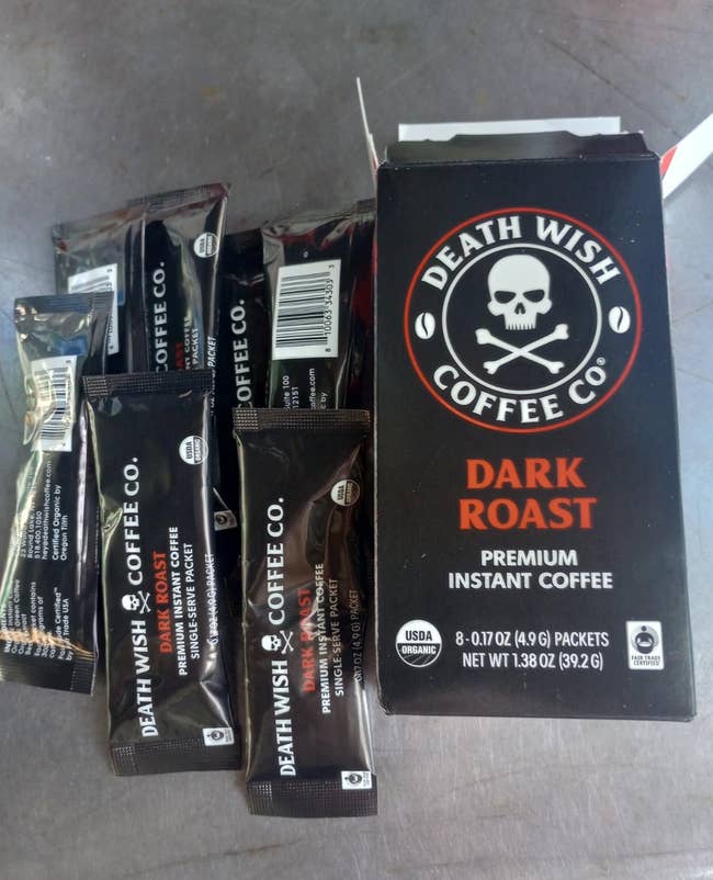 Death Wish Coffee Co. Dark Roast Instant Coffee container  with single-serve packets displayed astir   it