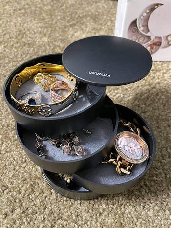 reviewer image of rotating black multilayered tray with jewelry inside