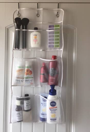 another reviewer's organizer on the bathroom door holding toiletries 