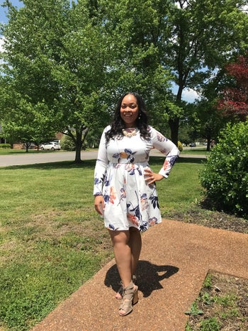 a reviewer wearing the dress in white with florals on it