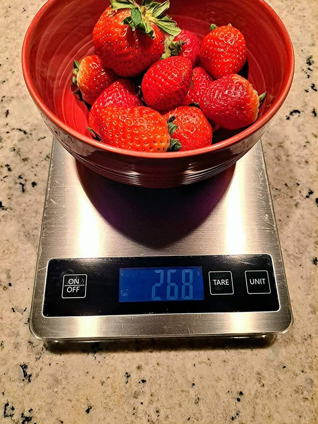 reviewer's stainless steel kitchen scale with a bowl of strawberries on it