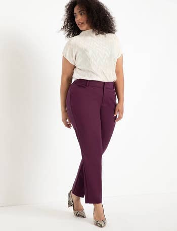 model wearing the burgundy pants with a white top