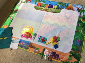 the mat, which has a dinosaur-themed border