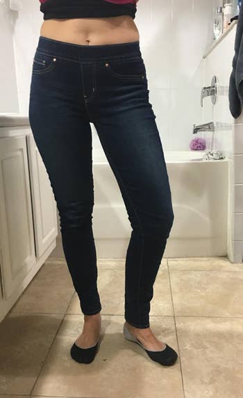 front view of a reviewer in dark wash jeggings