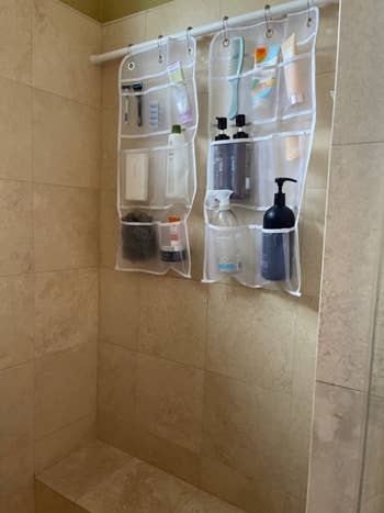 reviewer's same shower with all the toiletries hanging up in two mesh organizers